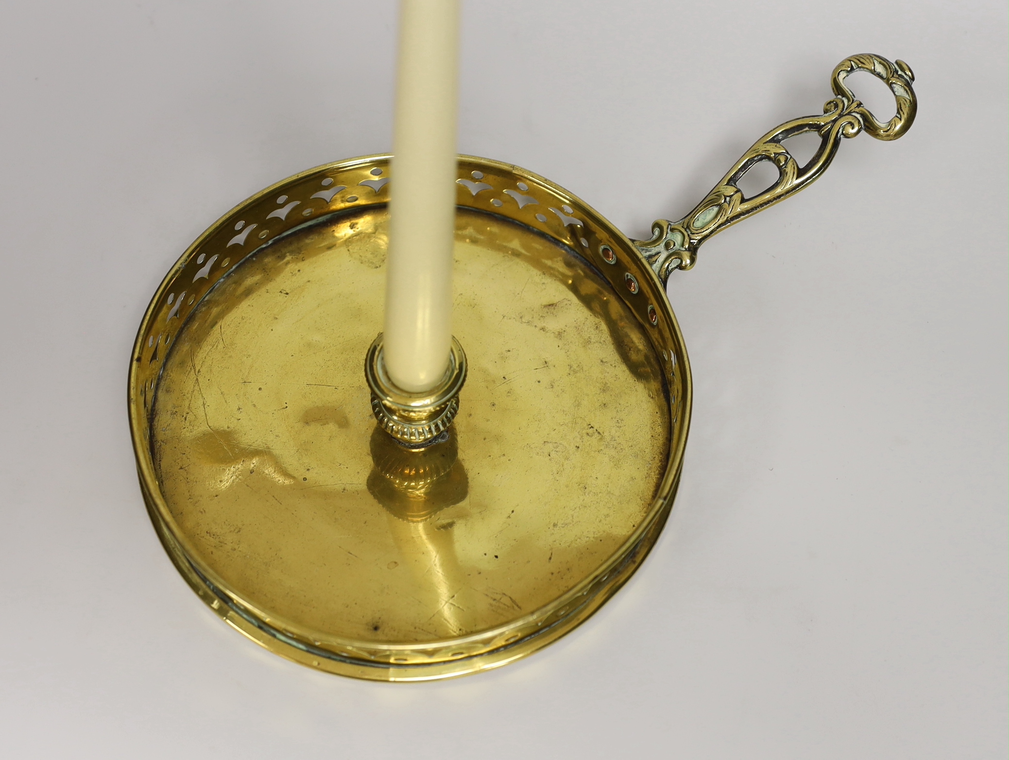 A brass chamberstick, with a wide drip pan and pierced galleried border, 32cm wide